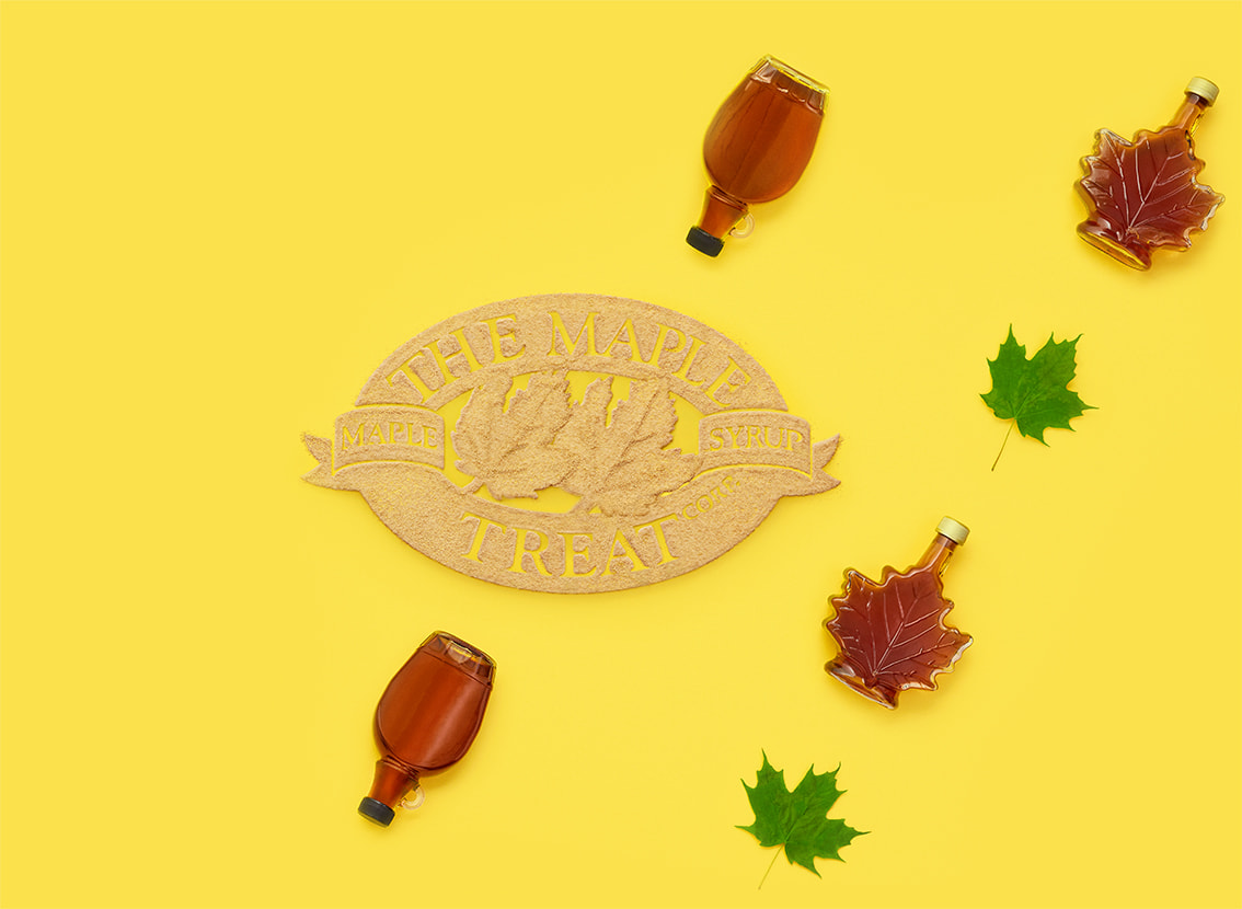 The Maple Treat Corp. logo made with maple sugar with bottles of maple syrup and maple leaves surrounding it.